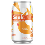 Apricot + Mango can, orange curled teardrops in the background with darker orange flower shapes in the foreground.